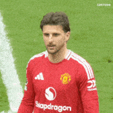 a soccer player wearing a red shirt that says siapdragon