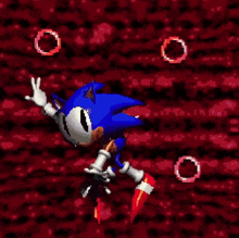 sonic the hedgehog is jumping in the air in a video game with red rings around him .