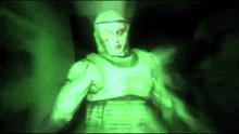 a man in a gas mask is standing in a dark room .