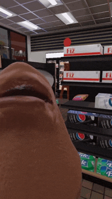a man 's face is in front of a shelf of fiz boxes