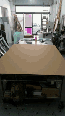 a large piece of cardboard is on a table in a workshop