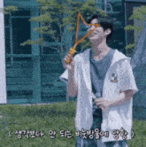 a man in a white jacket is blowing soap bubbles in a field