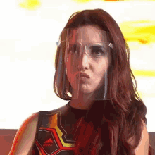 a woman is wearing a face shield and making a funny face