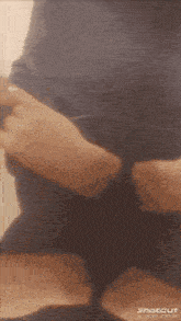 a blurred image of a person 's torso with the word shotcut on the bottom right