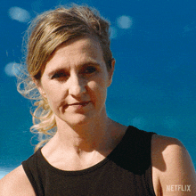 a woman wearing a black tank top that says netflix