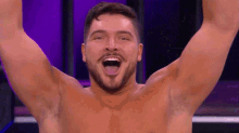 a shirtless man with his arms in the air and his mouth open .