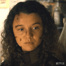 a close up of a woman 's face with a netflix logo on the bottom