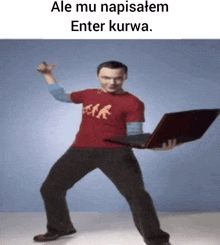 a man in a red shirt is holding a red laptop