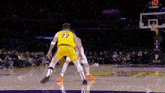 a basketball player with the number 77 on his shorts is defending another player