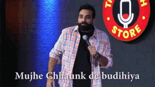 a man is holding a microphone in front of a sign that says comedy store