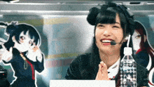 a girl with a microphone and a bottle of water in front of her