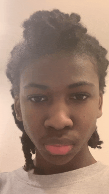 a young man with dreadlocks has a pink lip