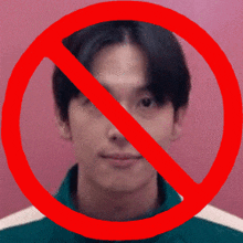 a man 's face is surrounded by a red circle with a line through it