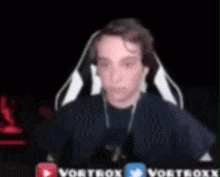 a blurry picture of a man wearing headphones and a vortexx logo on the bottom