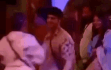 a group of people are dancing together in a room in a blurry photo .