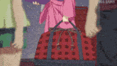 a woman in a pink kimono is holding a red and black bag