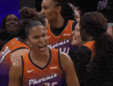 a group of female basketball players are wearing phoenix uniforms