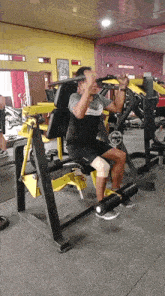 a man with a knee brace is using a machine in the gym