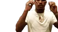 a man wearing glasses and a white shirt adjusts his earring