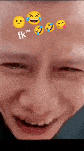a close up of a man 's face with smiley faces on his forehead .