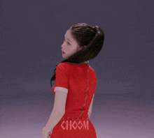 a woman in a red dress is standing in front of a studio showm sign