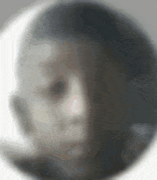 a blurry picture of a person 's face with a circle around it
