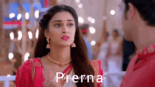 a woman in a pink top is standing next to a man in a red shirt and the words piruenna are on the bottom right