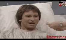 a man laying in a hospital bed with the name emma lyons on the bottom