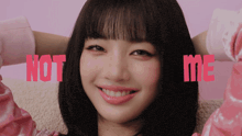 a girl in a pink shirt is smiling with the words not me behind her