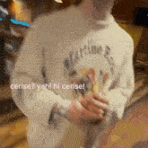 a person wearing a martine sweater is standing in a room