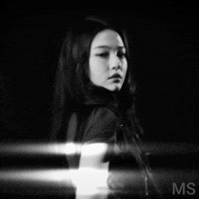 a black and white photo of a woman with ms on the bottom right