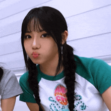 a girl with pigtails is wearing a shirt that says octopus on it