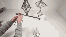 a person is playing with a set of magnetic balls on a table