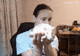 a girl holding a white rat in her hands with pixverse.ai written on the bottom