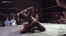 a jcw wrestling match is being shown on a screen