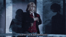 scarlet fox is standing in front of a window with his hands on his chest