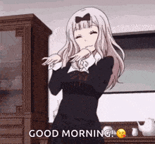 a girl in a black dress is dancing in a kitchen and says good morning