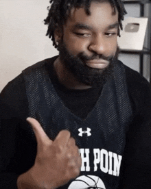 a man with a beard wearing a jersey that says h poin