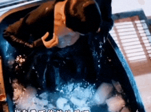 a man is sitting in a bathtub filled with ice .