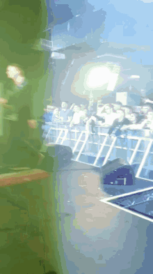 a blurred image of a crowd at a concert with a sign that says ' i love you ' on it