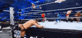 a man is kneeling down in a wrestling ring during a wrestling match .