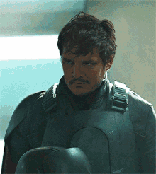 a man with a mustache is wearing a helmet and armor