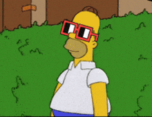 homer simpson wearing sunglasses is standing in front of a hedge