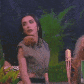 a woman in a green dress is standing next to another woman in a green dress