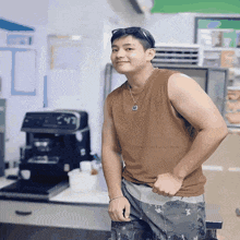 a man in a brown tank top is standing in front of a coffee machine with the words " your hot coffee " on the bottom