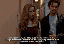a man and a woman standing next to each other with a quote that says " loving someone and being loved "