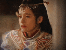 a woman with a crown on her head has tears coming out of her eyes