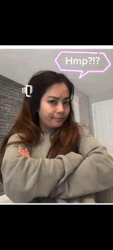 a woman with her arms crossed and a speech bubble that says hmp on it .