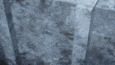 a person is standing next to a large block of ice and says `` no '' .