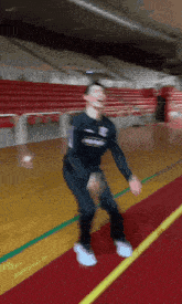 a blurred image of a person jumping on a gym floor